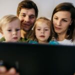 Family reviewing a home safety checklist together in their living room.
