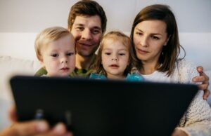 Family reviewing a home safety checklist together in their living room.