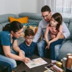 Family reviewing an emergency communication plan together at the kitchen table.