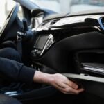 An organized glove compartment and essentials showing what to keep in your car.
