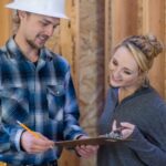 Homeowner reviewing renovation plans and an estimate with a contractor