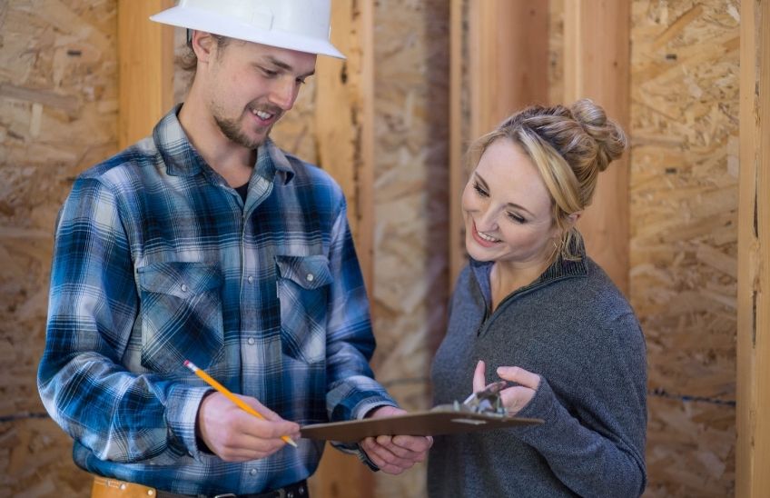 Homeowner reviewing renovation plans and an estimate with a contractor