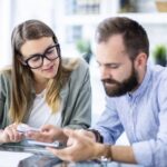 Couple reviewing household changes and insurance documents at home