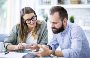 Couple reviewing household changes and insurance documents at home