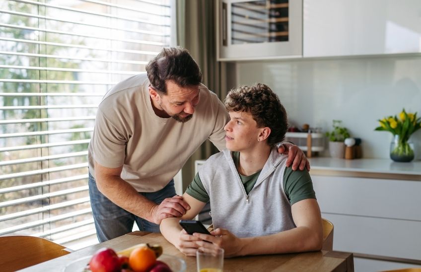 Parent talking with a teen driver before handing over the car keys